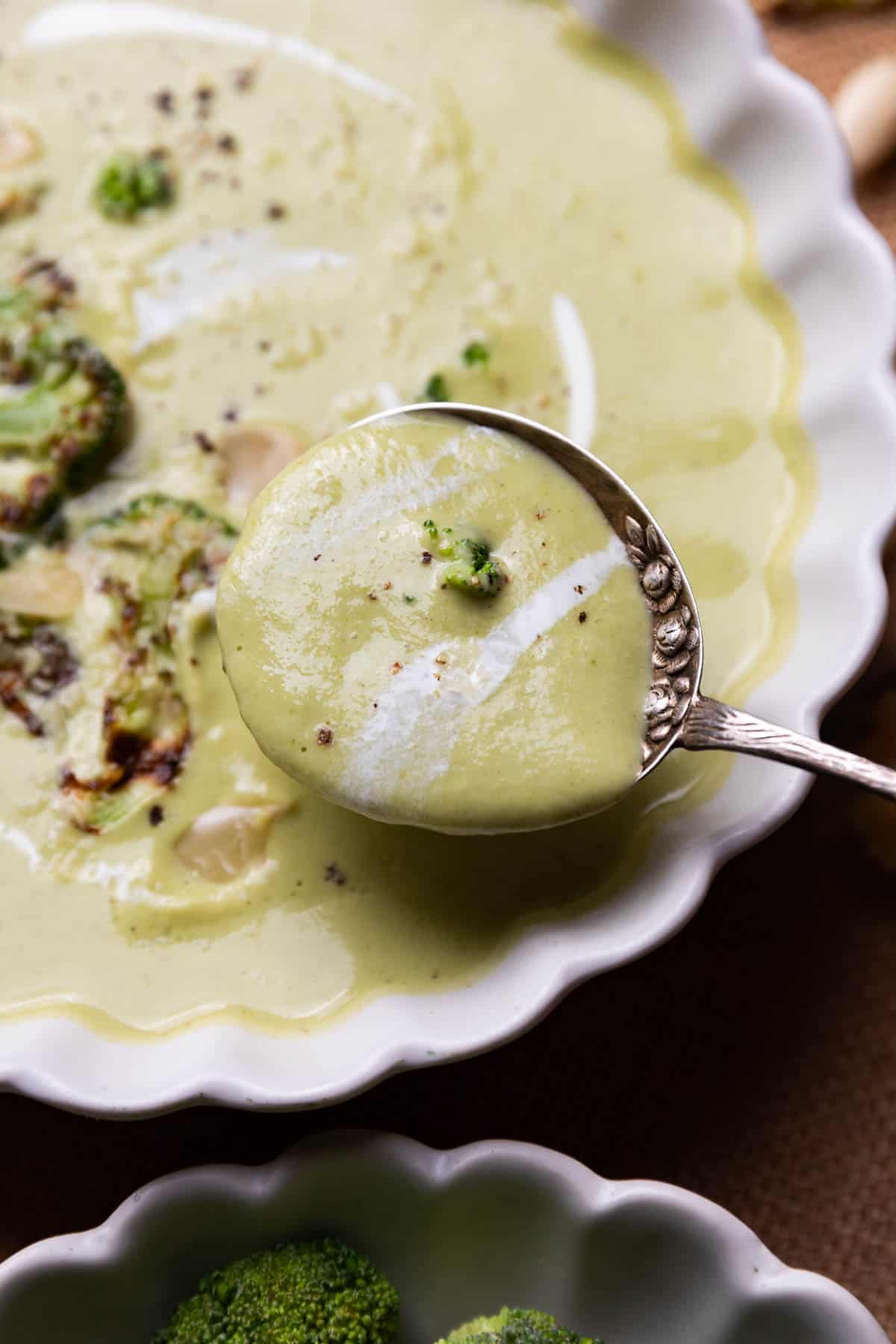 a close up image of broccoli almond soup to show it's creamy texture