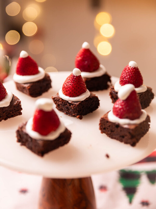 a festive image of brownie bites served on a white stand