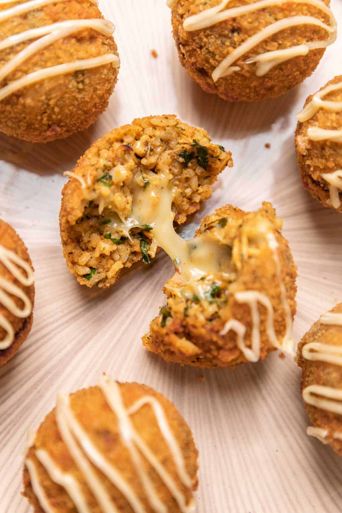 a chicken curry rice ball cut into half to show the texture and cheesy middle