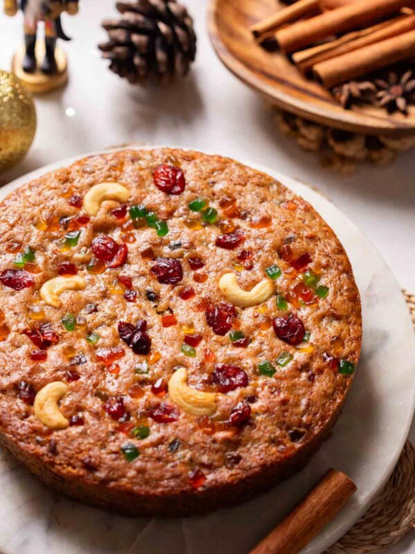 close up image of a whole eggless plum cake
