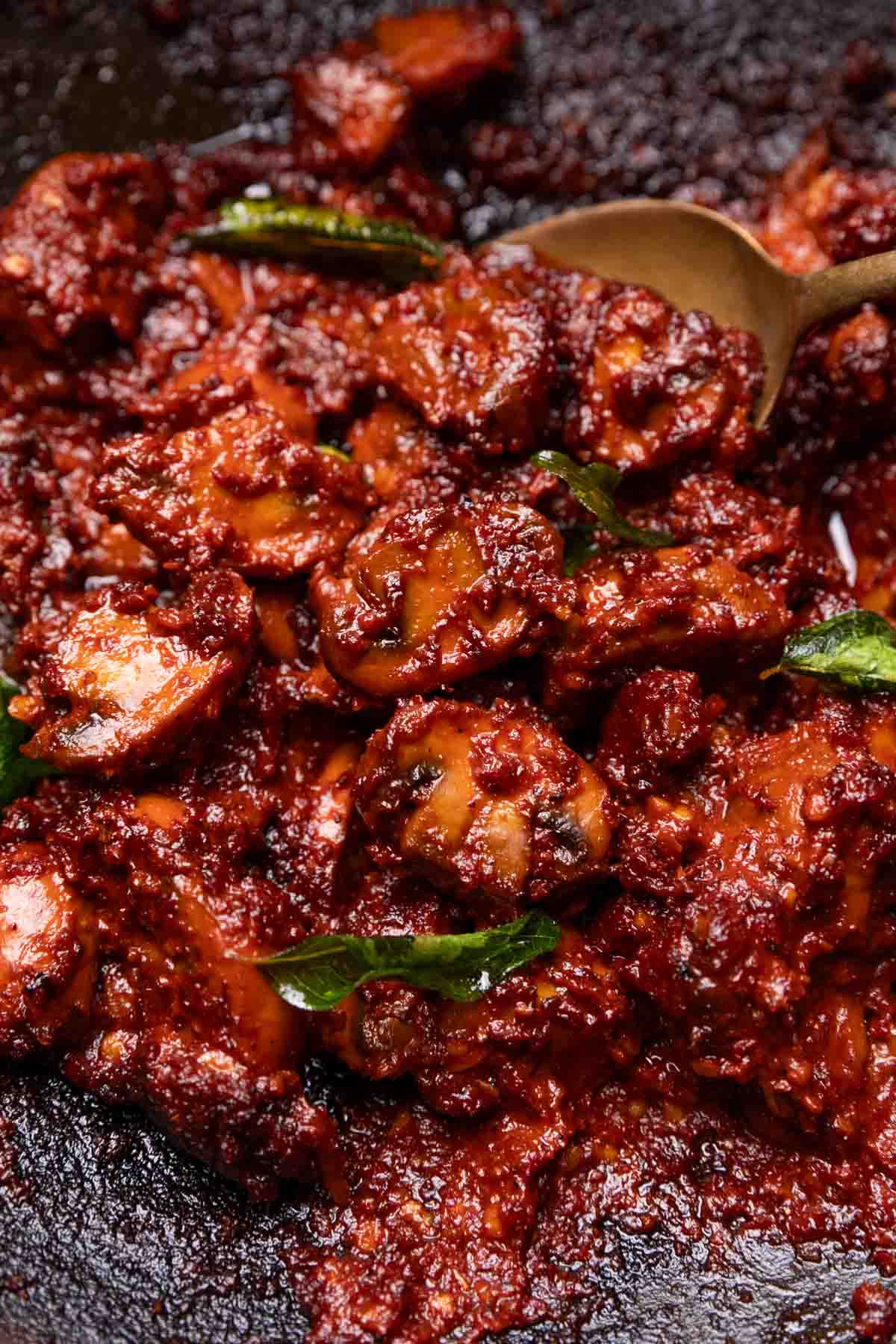 close up image of mushroom ghee roast in a pan