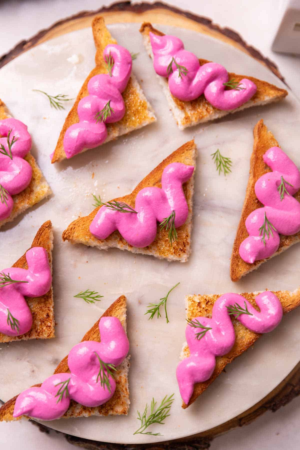 an image of several paneer toasts served on a round white platter