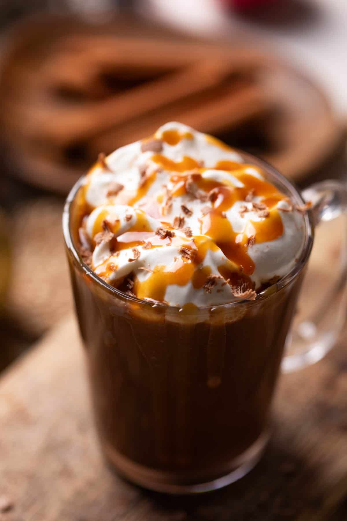 salted caramel hot chocolate topped with whipped cream and caramel served in a mug