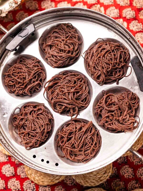 freshly steamed ragi idiyappams placed in a in steamer