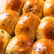 air fryer rolls brushed with butter and sesame seeds
