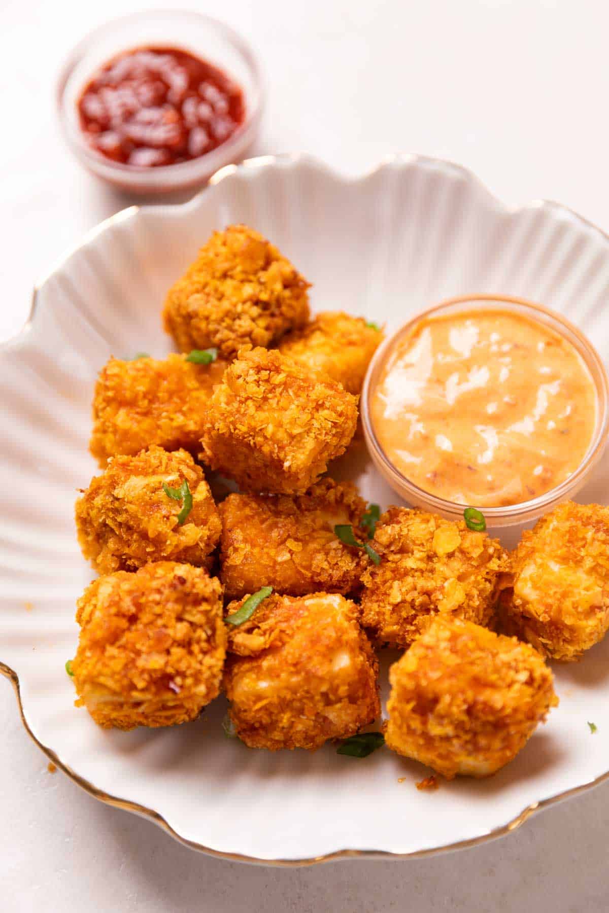 air fryer paneer popcorn served on a white plate with accompaniments