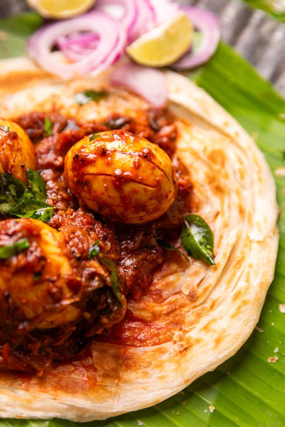 close up image of Kerala egg roast served on Malabar Parotta