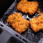 fried chicken cooking in an air fryer basket