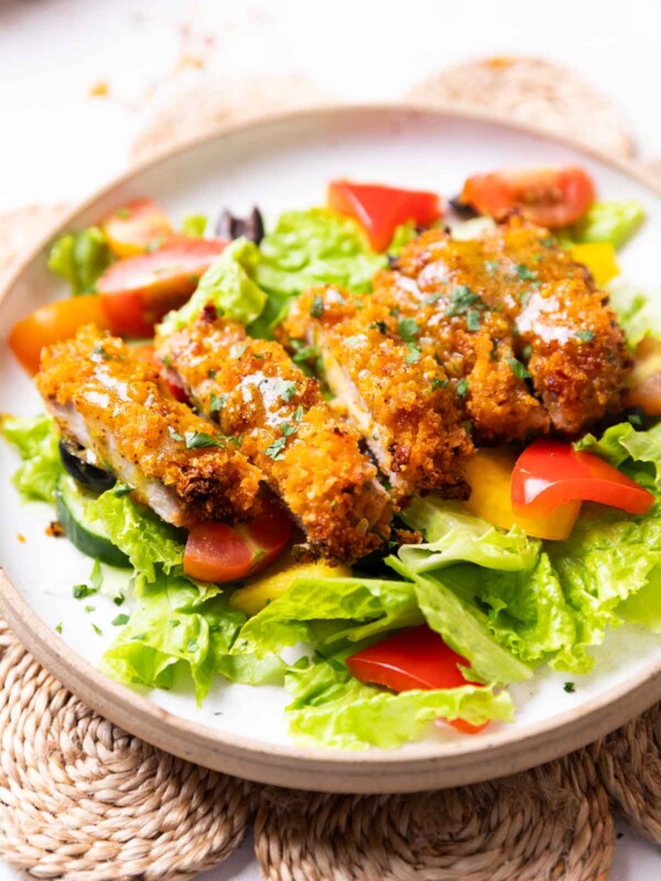 air fryer fried chicken served on a bed of lettuce and other veggies
