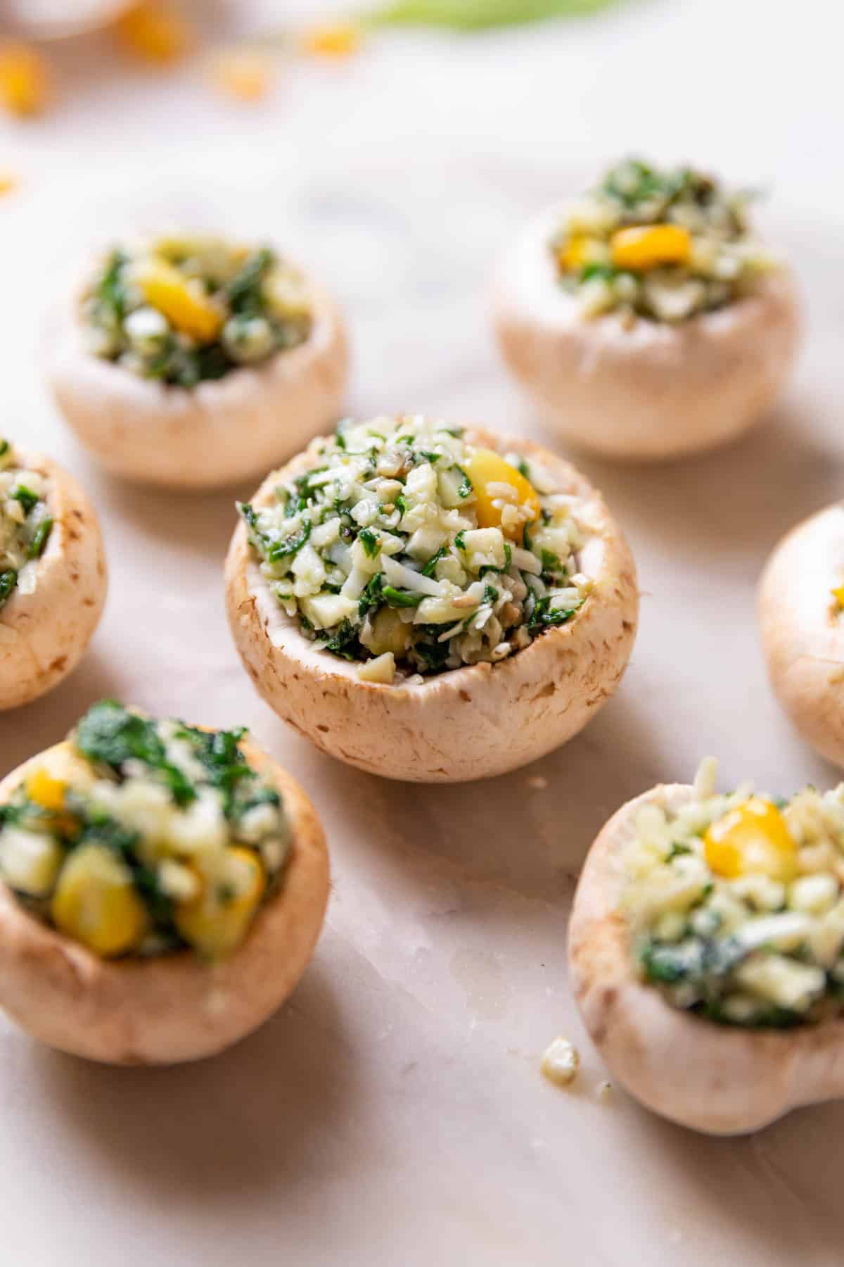 mushrooms stuffed with filling and ready to be air fried to make air fryer stuffed mushrooms