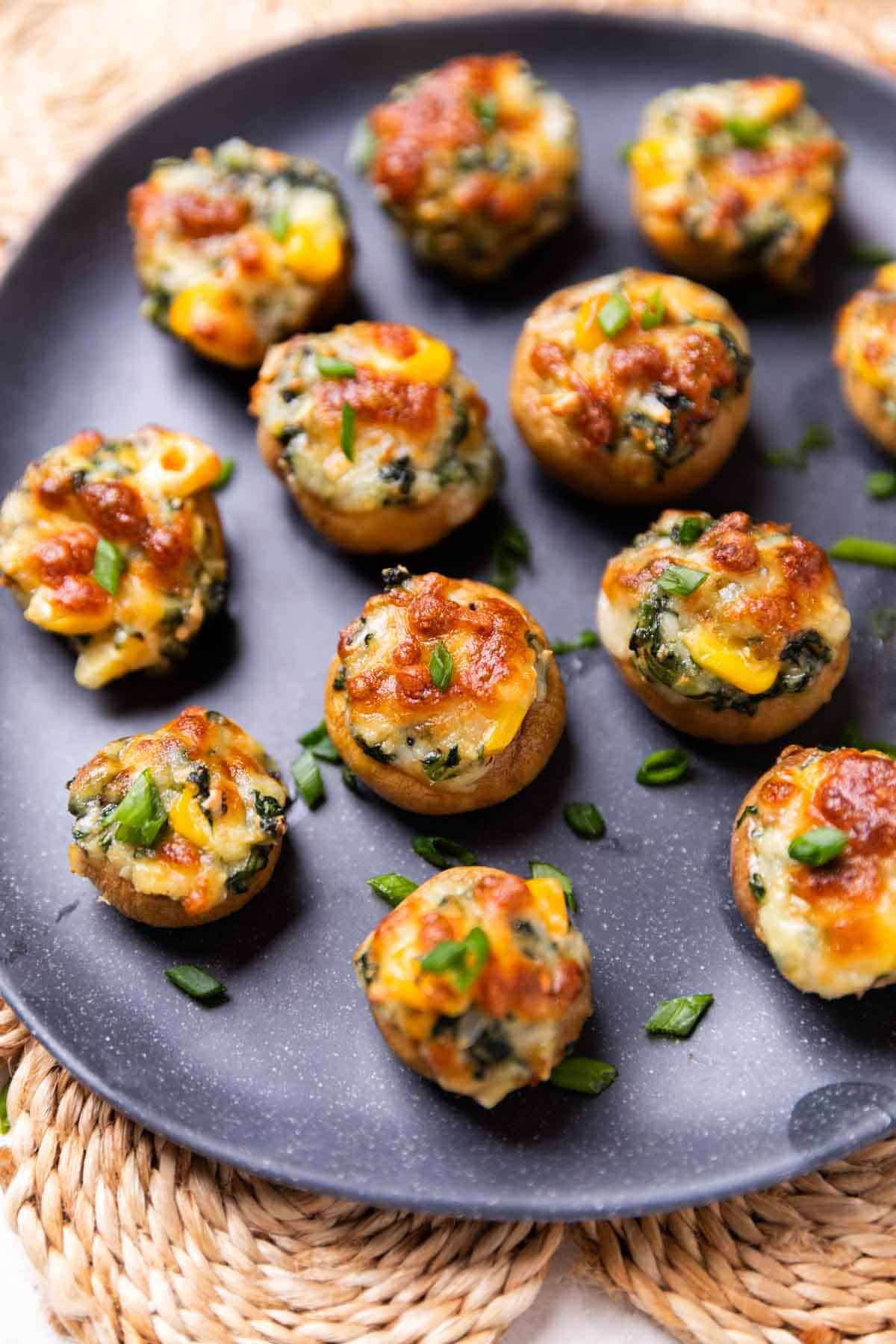 air fryer stuffed mushroom served on a black plate  