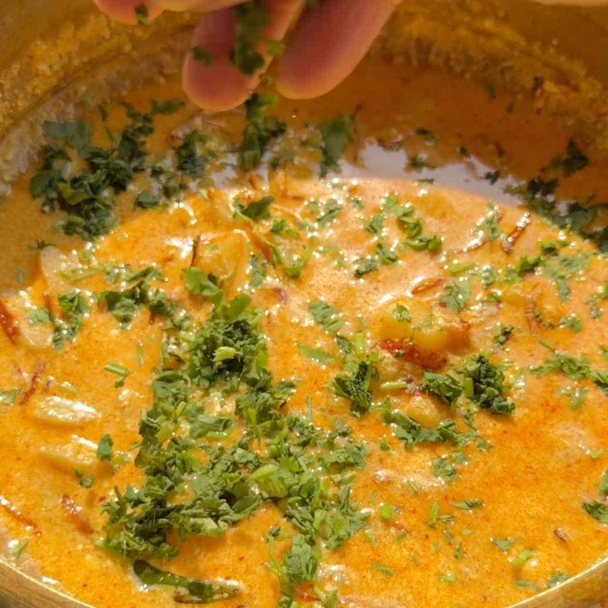 dahi tadka recipe - step 8 - garnish with coriander and serve