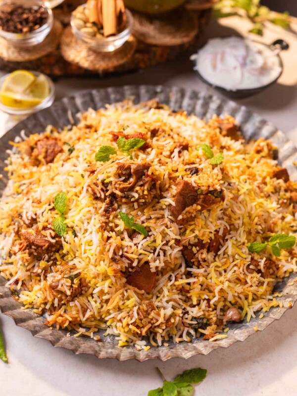 jackfruit biryani served on a platter with accompaniments