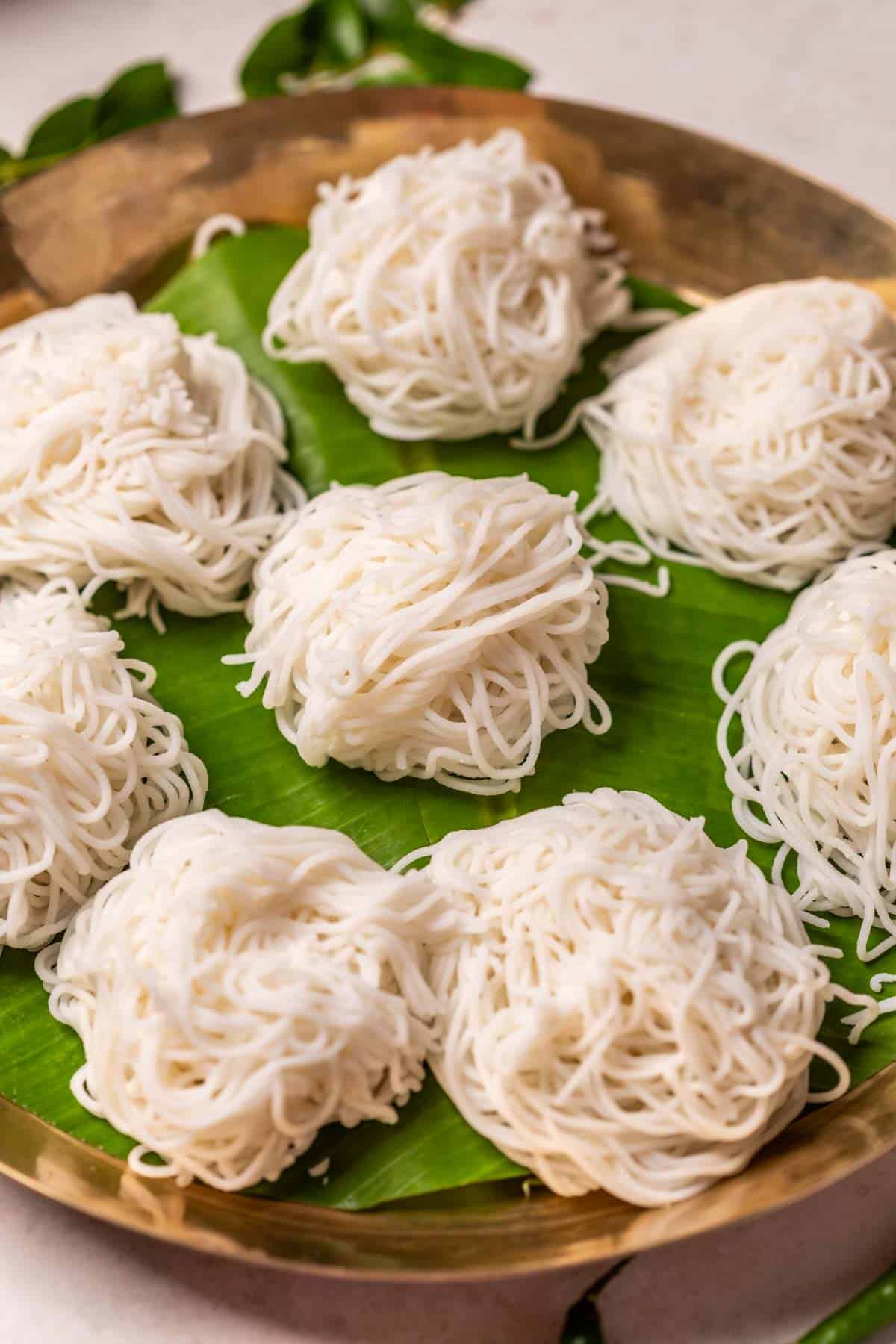 Rice idiyappams served on banana leaf in a plate