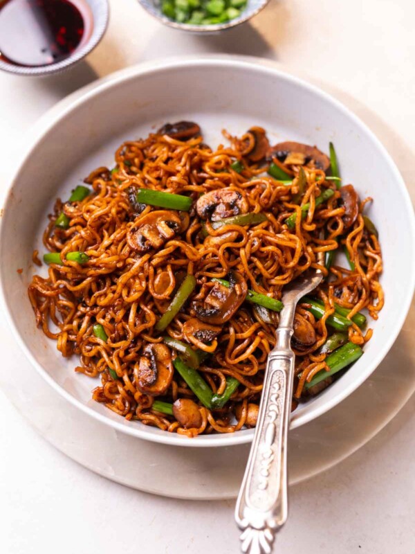 mushroom ramen noodles served in a white dish with a fork