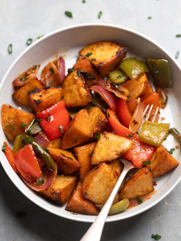freshly made idli fry served in a white bowl with a fork