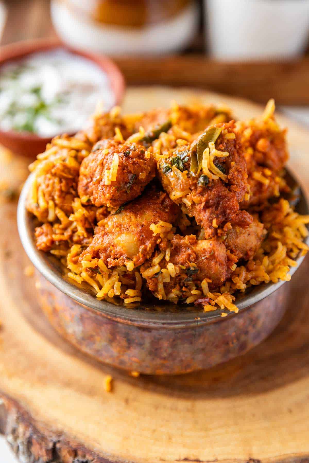 boneless chicken biryani served in a copper handi style bowl 