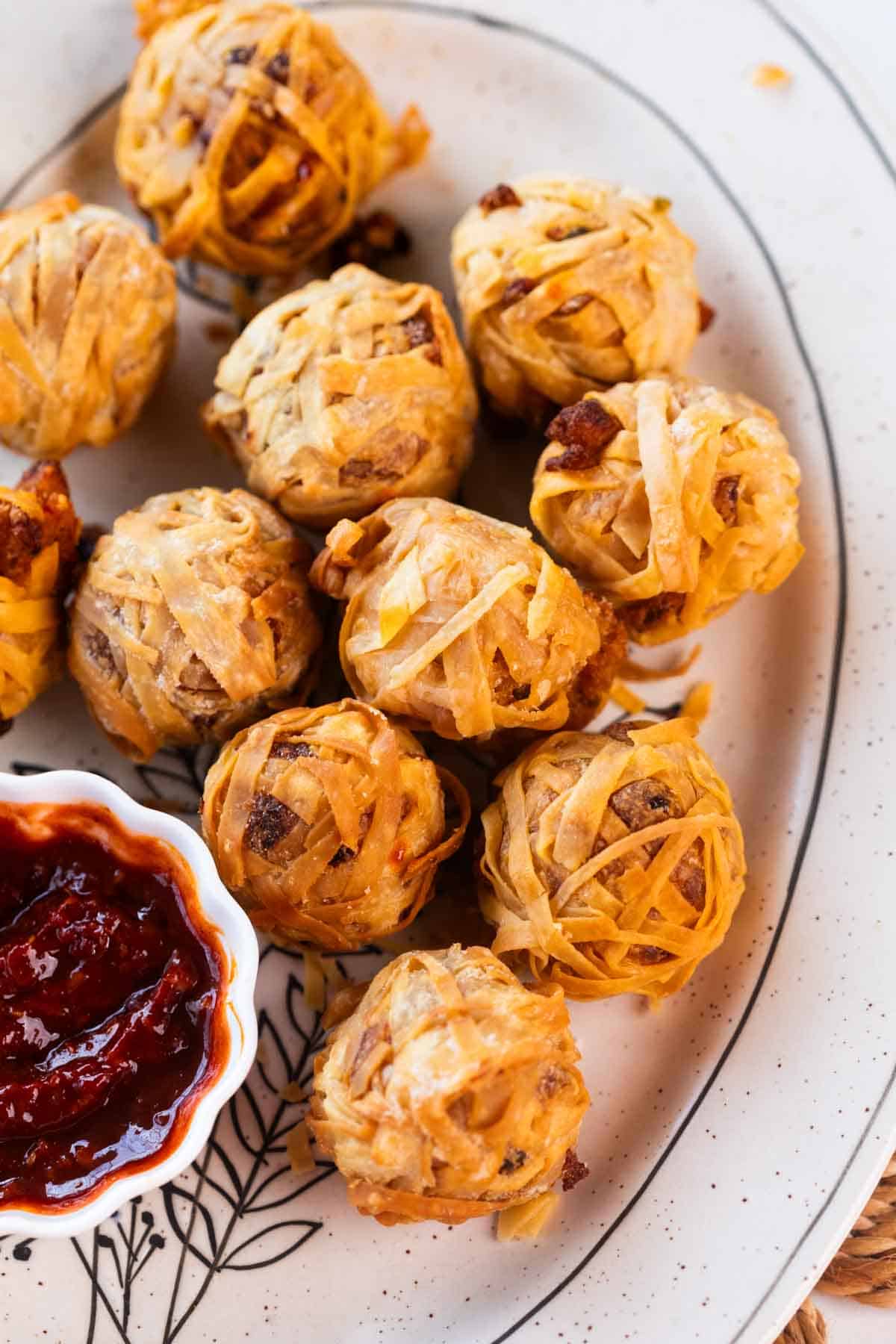 firecracker crispy potato balls served on a white plate with a dip