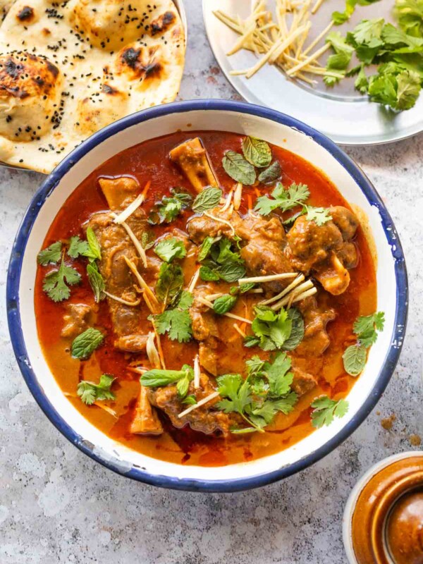 mutton nihari served on a bowl and garnished with coriander and julienned ginger