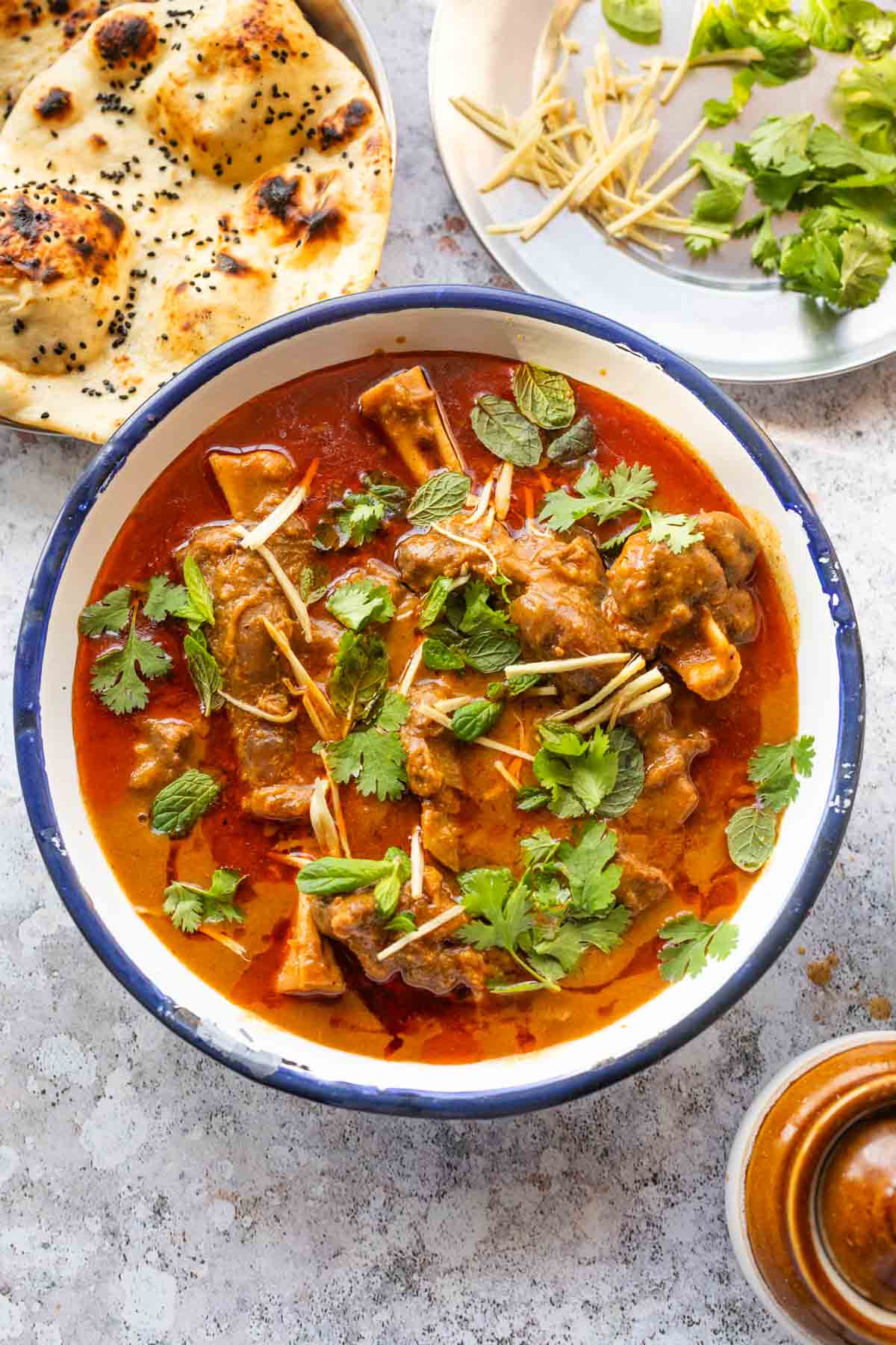 mutton nihari served on a bowl and garnished with coriander and julienned ginger  