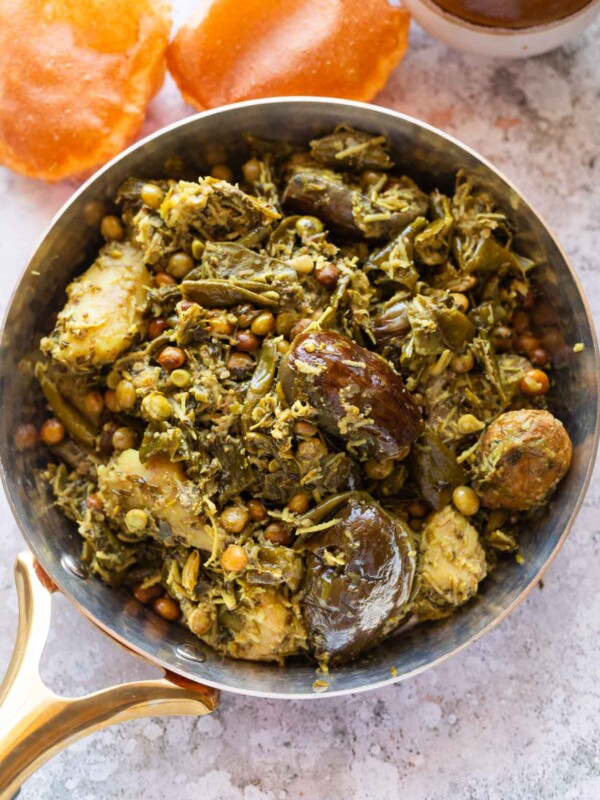an image of shortcut undhiyu still in a pan with accompaniments