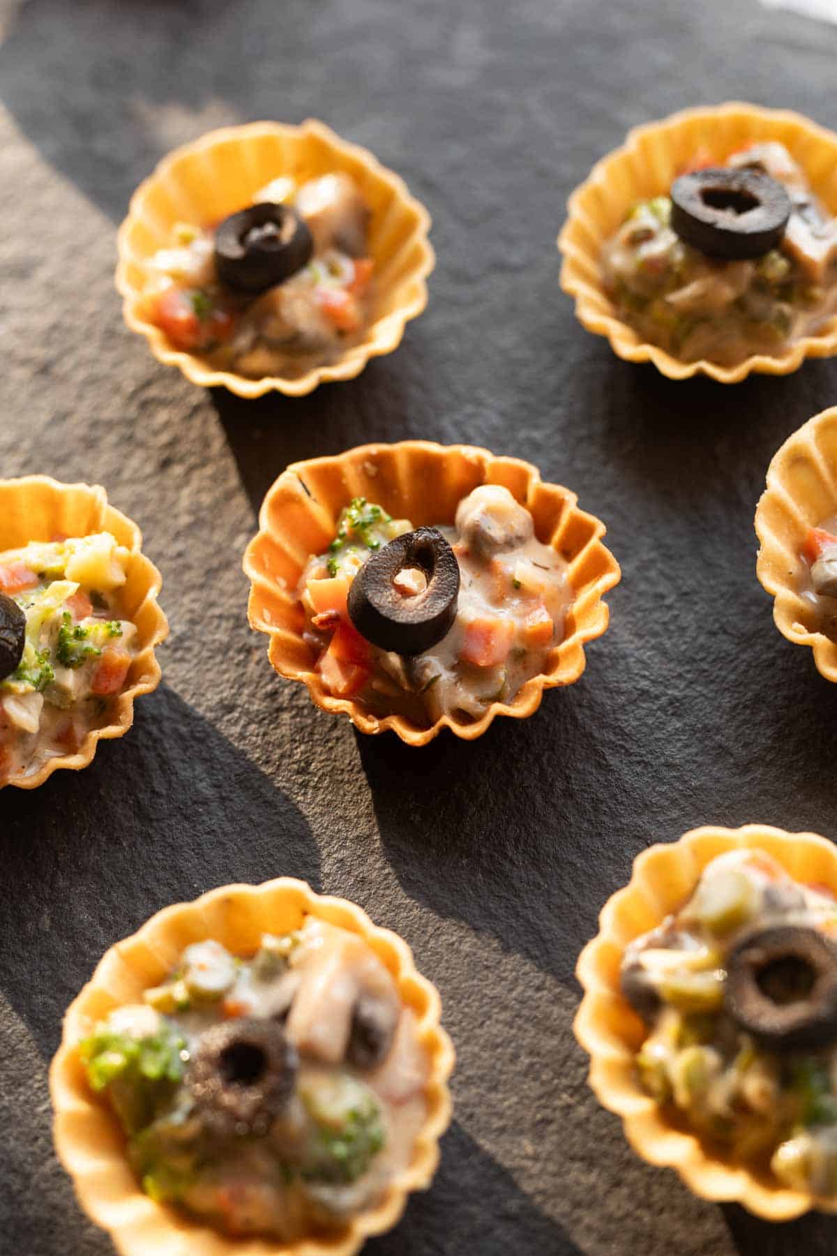 veg canapes sered on a black board ready to be eaten