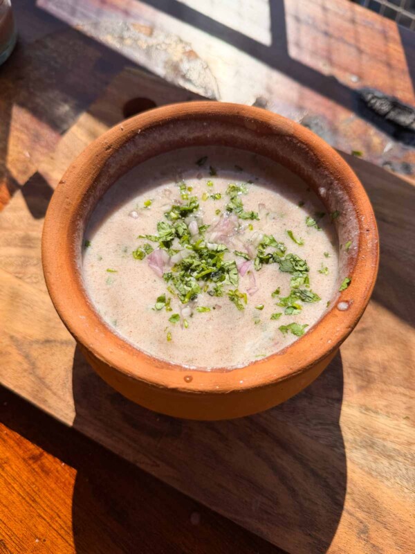 an earthen bowl with ragi ambli in it
