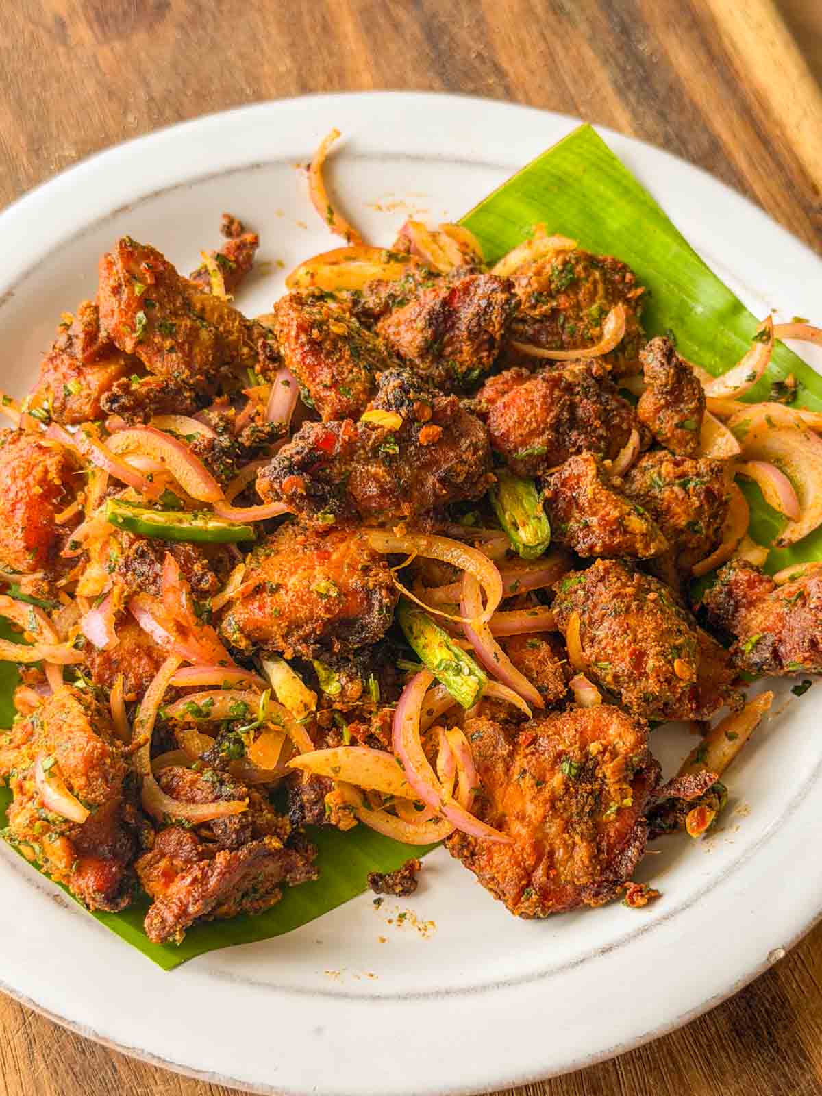 an image of chicken bites served on a white plate